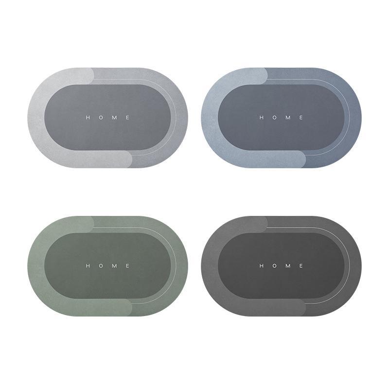 Vier ovale Tischsets in Grau und Grün mit "HOME"-Aufschrift, modernes Design, rutschfest.