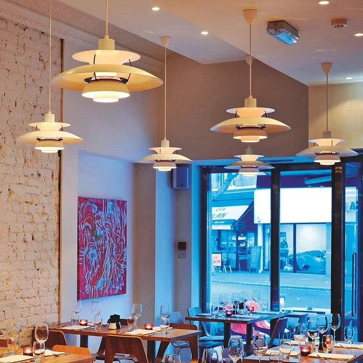 Moderne weiße Pendelleuchten im skandinavischen Design in stilvollem Restaurantambiente.