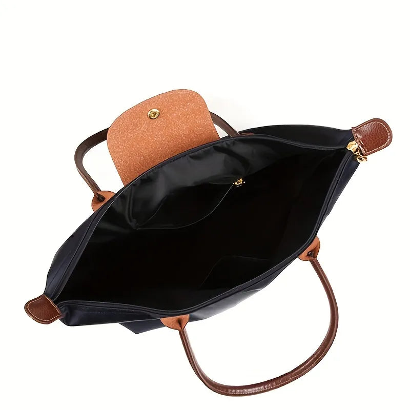 Schwarze Handtasche aus Leder mit braunen Griffen und offenem Innenfach, elegant und geräumig.