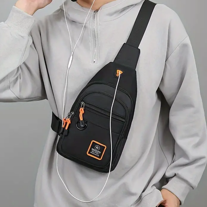 Schwarze Umhängetasche mit orangefarbenen Details, ideal für Reisen und Freizeit.