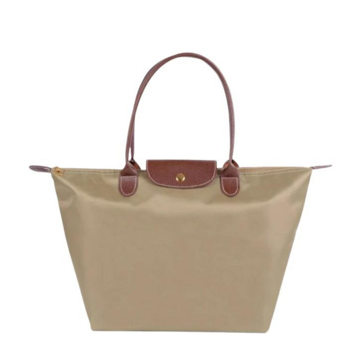 Beige Damenhandtasche aus Leder und Stoff, elegantes Design, braune Henkel.