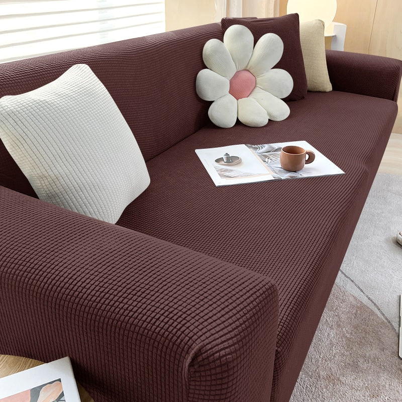Braunes Sofa mit strukturiertem Stoff, dekoriert mit Blumen- und Kissen, modernes Wohnzimmer.