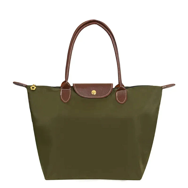 Grüne Damenhandtasche aus Nylon mit braunen Ledergriffen und Reißverschluss.