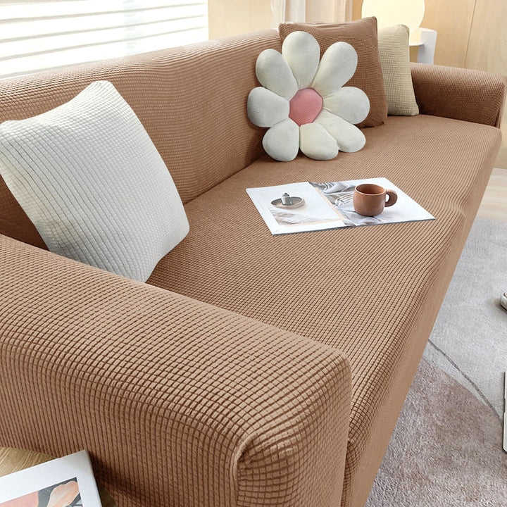 "Elastischer Sofabezug in Beige auf einem Sofa, stilvoller Schutz, passt perfekt durch Flexibilität, für Wohnzimmereinrichtun
