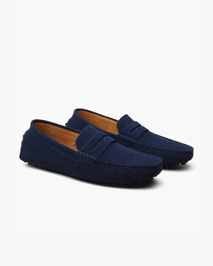 Eleganter Mokassin aus weichem Wildleder, klassisches Penny-Design, bequeme Gummisohle, verfügbar in Blau und Braun.