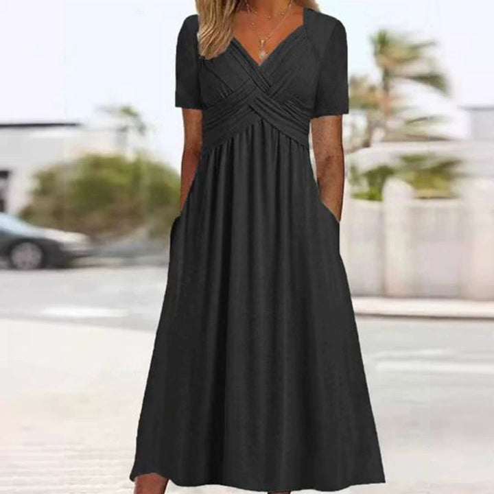 Elegantes Wickelkleid mit kurzen Ärmeln, knielang, ideal für warme Tage, in Grau, Grün, Hellblau und Marineblau.