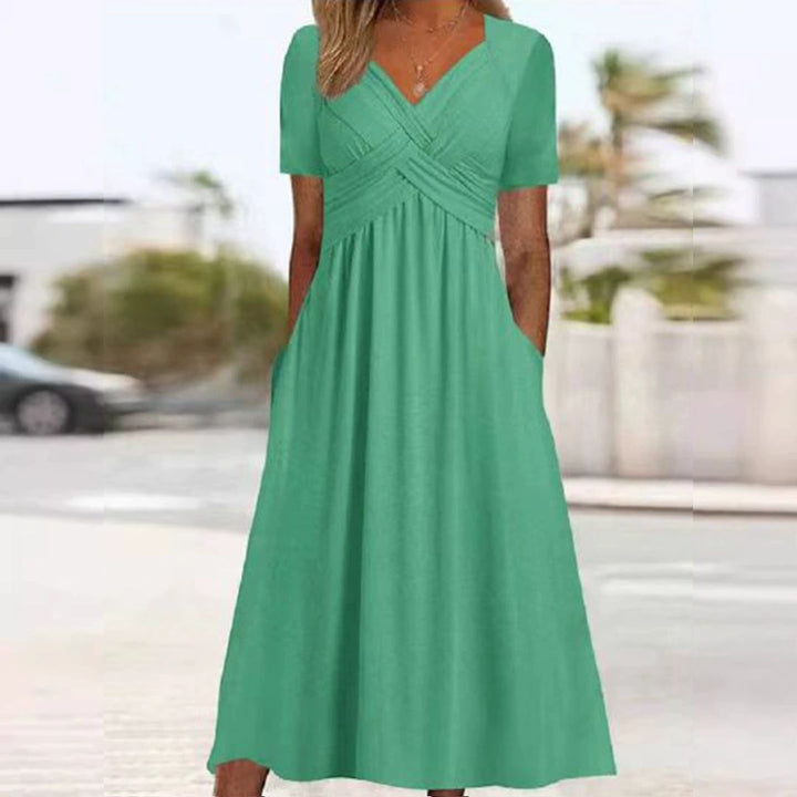 Elegantes Wickelkleid mit kurzen Ärmeln, knielang, ideal für warme Tage, in Grau, Grün, Hellblau und Marineblau.