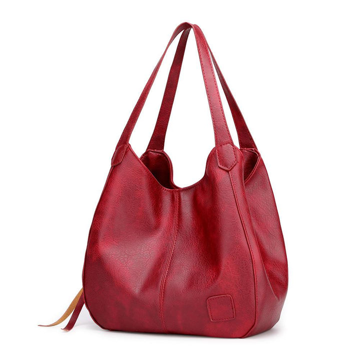 "Große stilvolle Ledertasche in Braun, Vintage-Design, ideal für Alltag und Reisen, mit sicheren Reißverschlussdetails."
