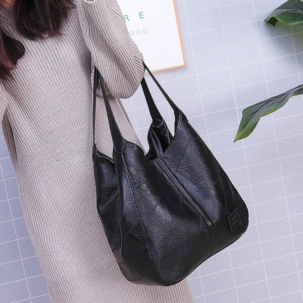 "Große stilvolle Ledertasche in Braun, Vintage-Design, ideal für Alltag und Reisen, mit sicheren Reißverschlussdetails."
