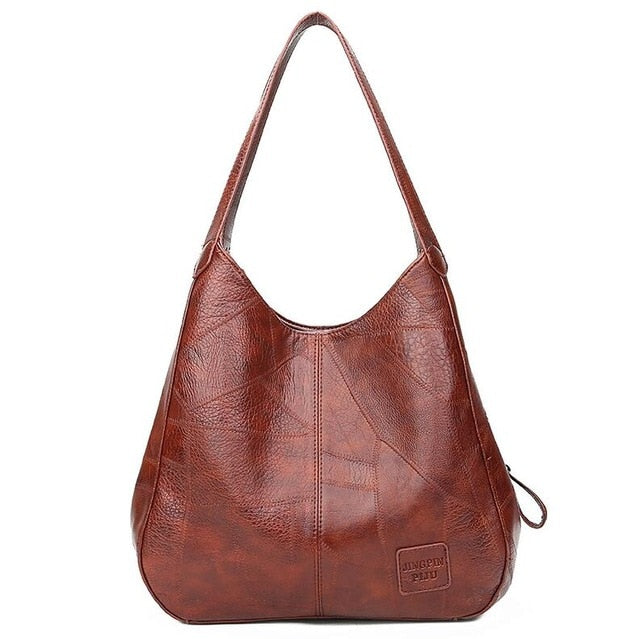 "Große stilvolle Ledertasche in Braun, Vintage-Design, ideal für Alltag und Reisen, mit sicheren Reißverschlussdetails."