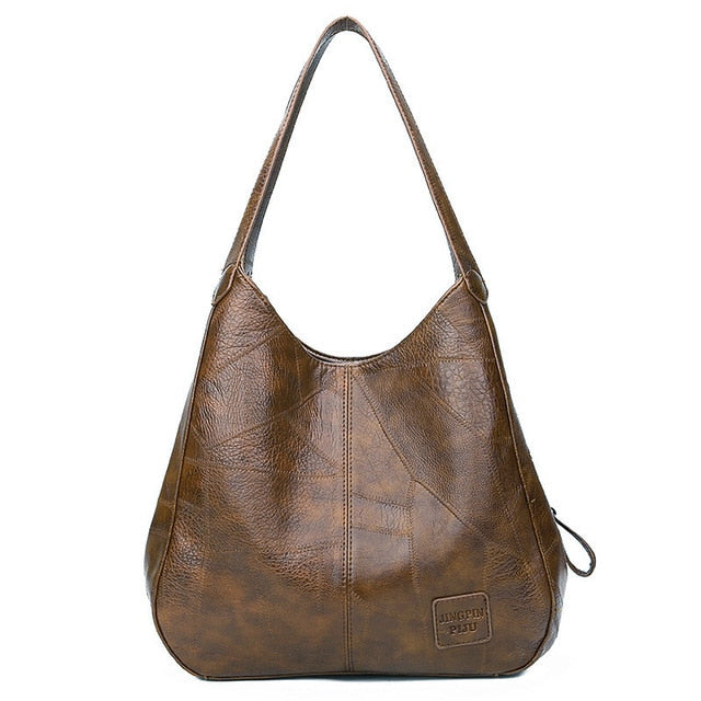 "Große stilvolle Ledertasche in Braun, Vintage-Design, ideal für Alltag und Reisen, mit sicheren Reißverschlussdetails."