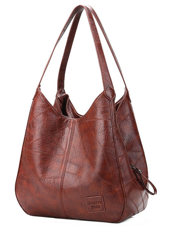 "Große stilvolle Ledertasche in Braun, Vintage-Design, ideal für Alltag und Reisen, mit sicheren Reißverschlussdetails."