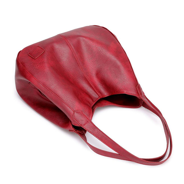 "Große stilvolle Ledertasche in Braun, Vintage-Design, ideal für Alltag und Reisen, mit sicheren Reißverschlussdetails."