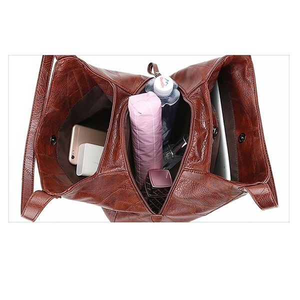 "Große stilvolle Ledertasche in Braun, Vintage-Design, ideal für Alltag und Reisen, mit sicheren Reißverschlussdetails."