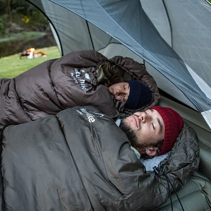 "Grüner ultraleichter Outdoor-Schlafsack, ergonomisches Design, optimal für kalte Nächte, isoliert und leicht tragbar."