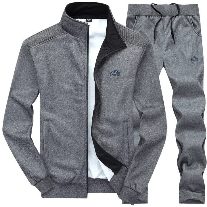 Herren Jogging Set in Grau, funktional & robust, mit Wind- & Wasserschutz, ideal für Outdoor-Training, Jacke & Hose.