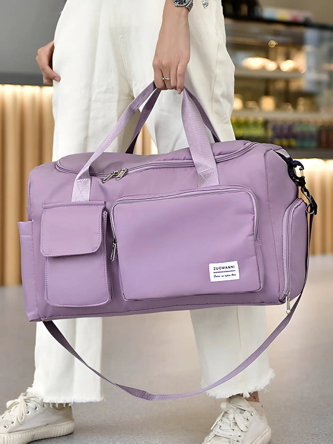Lila Reisetasche mit mehreren Fächern, Schultergurt, ideal für Reisen und Sport.