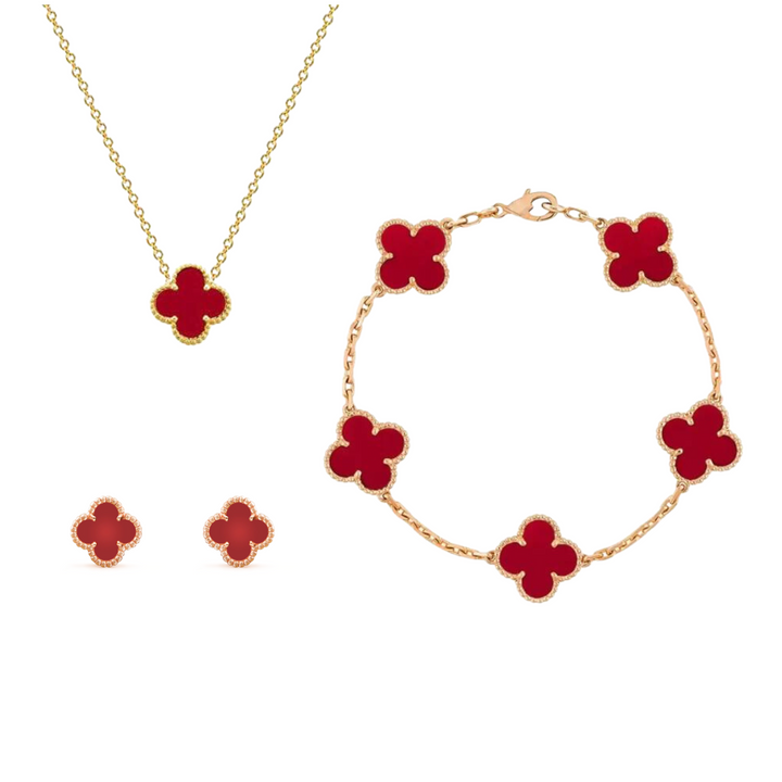 Goldene Halskette, Armband und Ohrringe mit roten Kleeblatt-Anhängern, Schmuckset.