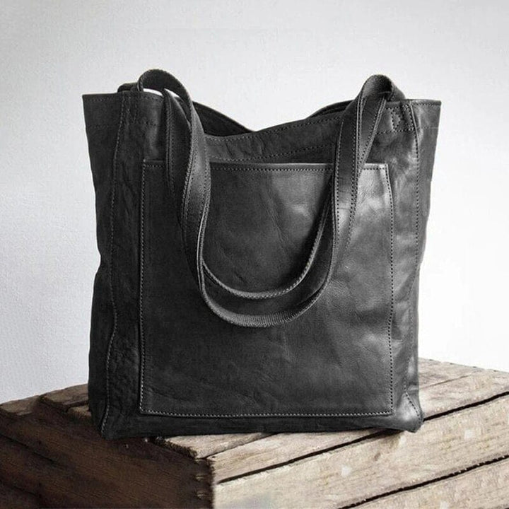 "Stilvolle Unisex Ledertasche vegan, braun, zeigt elegantes und funktionales Design von vorne"