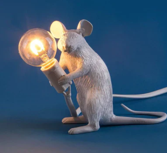 "Weiße Maus Tischleuchte in sitzender Position, strahlt warmes Licht, ideal für stilvolle Wohn- oder Schlafräume."